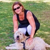 woman trainer crouching over dog
